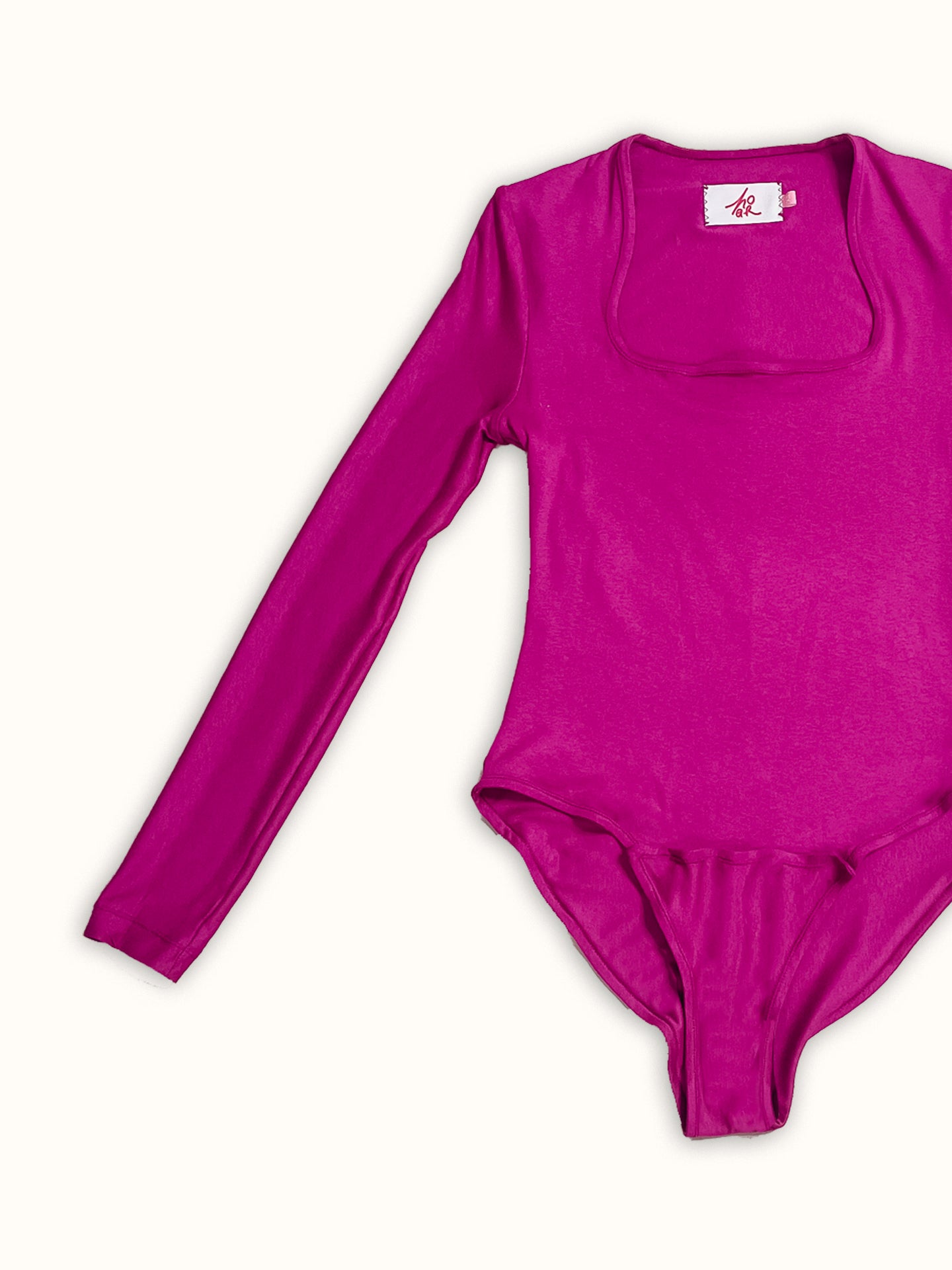 A colorful long-sleeve bodysuit made from jersey deadstock fabric, featuring a square neckline and a sleek, fitted design. A made-to-order piece