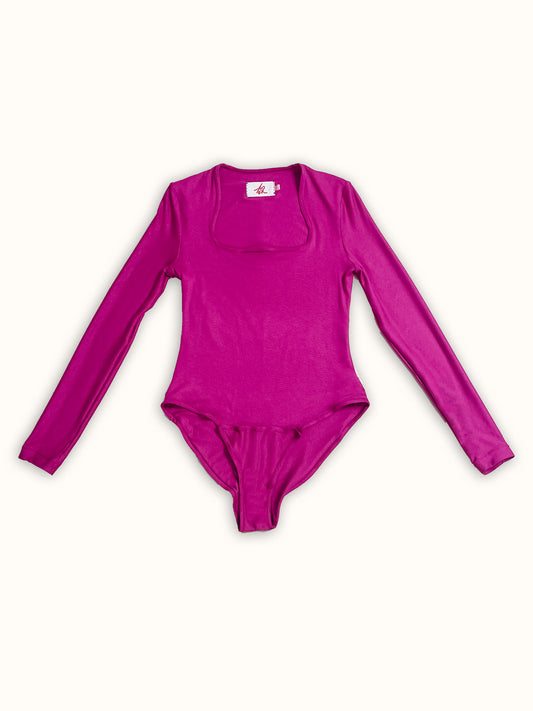 A colorful long-sleeve bodysuit made from jersey deadstock fabric, featuring a square neckline and a sleek, fitted design. A made-to-order piece